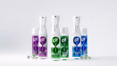 The image shows three Cif cleaning products in plastic spray bottles with refill packs shown alongside. There are three different product variants with purple, green and blue labels.