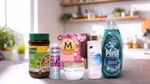 A variety of Unilever's Power Brands arranged on a kitchen counter. From left to right, you can see a jar of Knorr chicken bouillon, a Degree deodorant spray labelled "WHOLE BODY DEO", a box of Magnum ice cream labelled "UTOPIA", a bottle of Dove body lotion pro-ceramides serum, a jar of Dove Intensive Repair cream and a bottle of Persil Wonder Wash. In the background, there's a modern kitchen with plants and various items on the shelves.