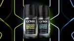 Two Lynx lower body spray bottles side by side, featuring Pear and Cedarwood scent, and Coconut and Sandalwood scent, against a neon background.