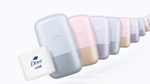 A row of stylish Dove refillable containers in soft colors, with a white refill pack prominently displayed in the front.